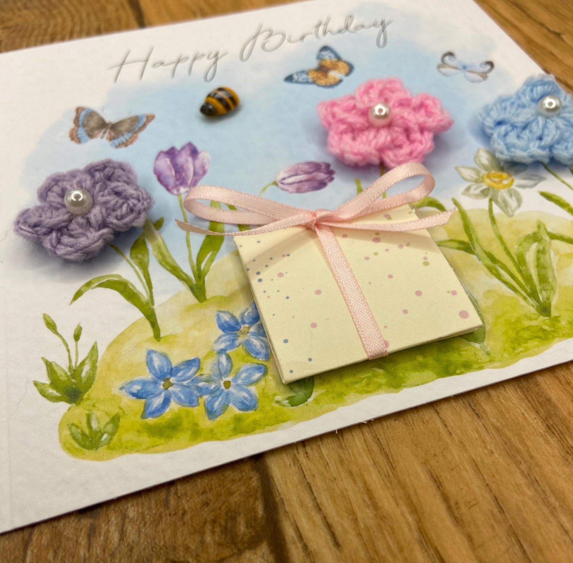 handmade birthday card featuring crochet flowers and includes a packet of bee friendly flower seeds