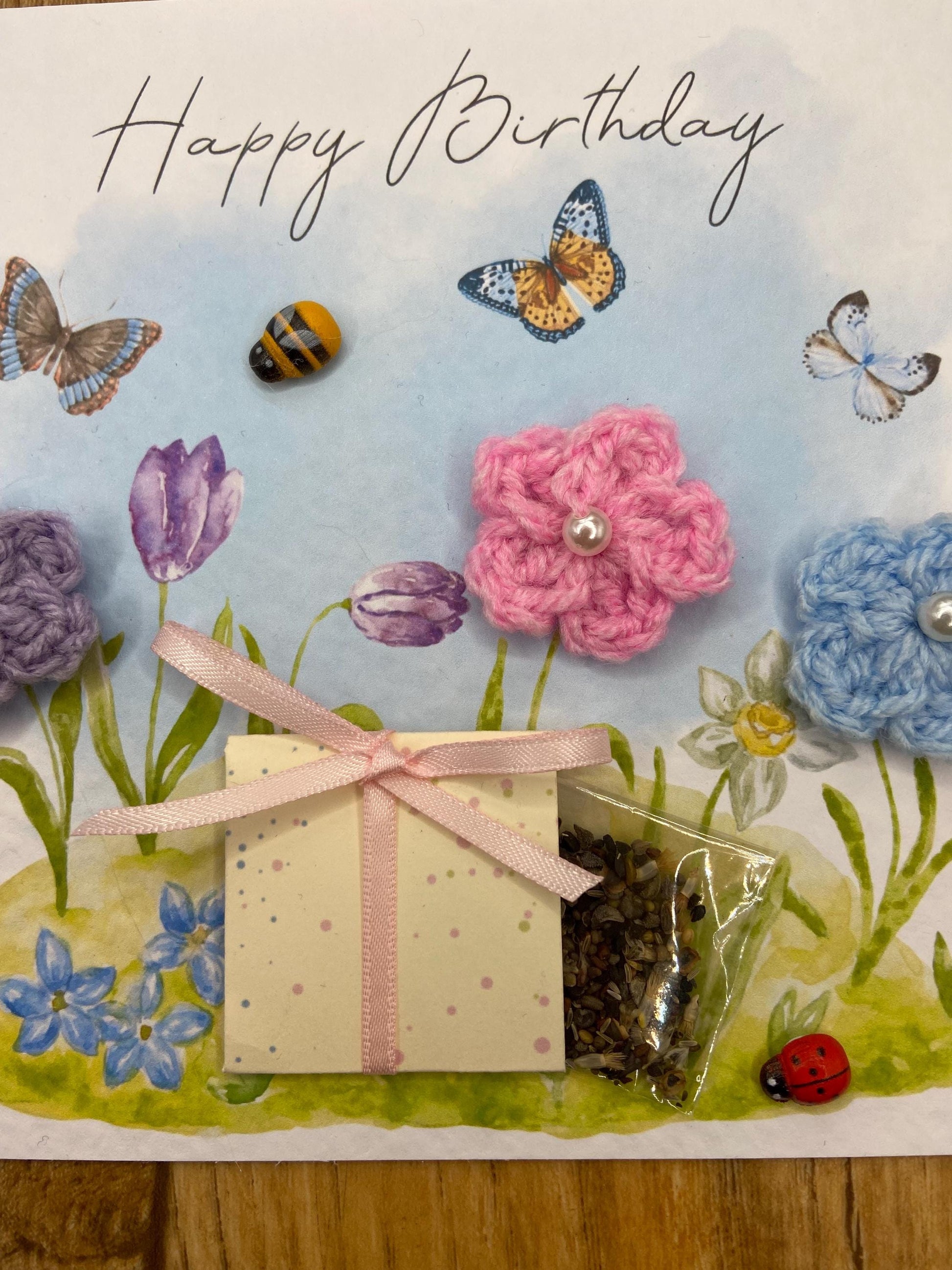 handmade birthday card featuring crochet flowers and includes a packet of bee friendly flower seeds