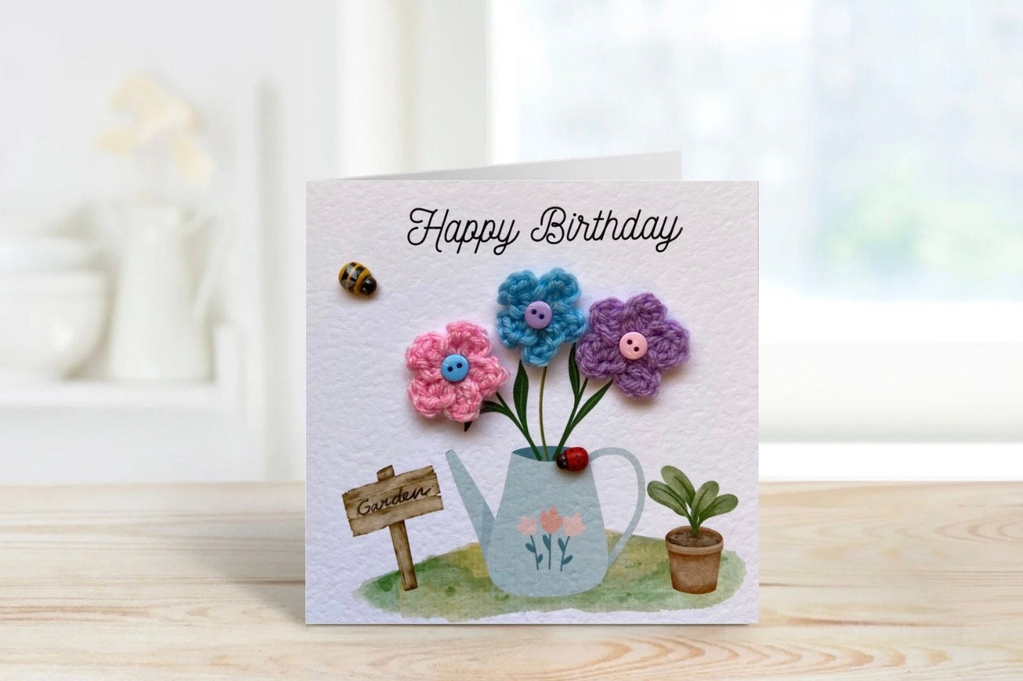 handmade birthday card with watering can and crochet flowers